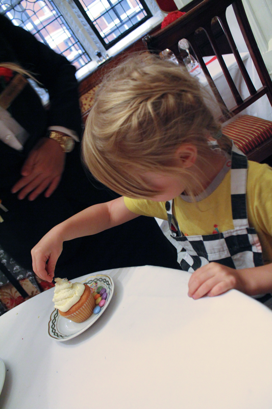 Decorating a cupcake at the Milestone Hotel