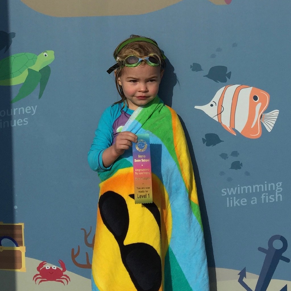 HJ receiving her swim lesson ribbon